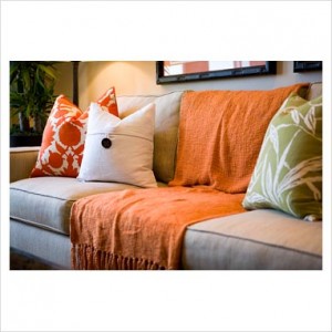 Modern sofa with orange throw blanket