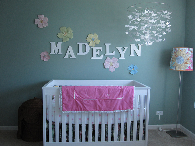 Idea for girl's nursery with name decor and floral wall decals