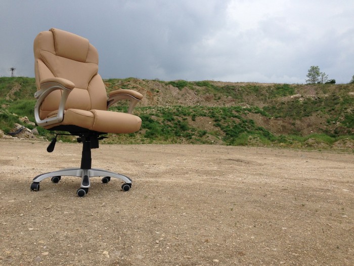 a lonely office chair in the middle of nowhere