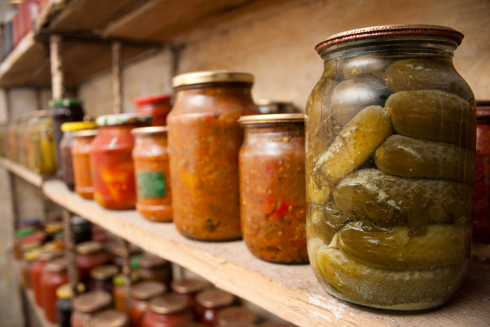 Storing food in pantry -  bottle with pickles and food containers